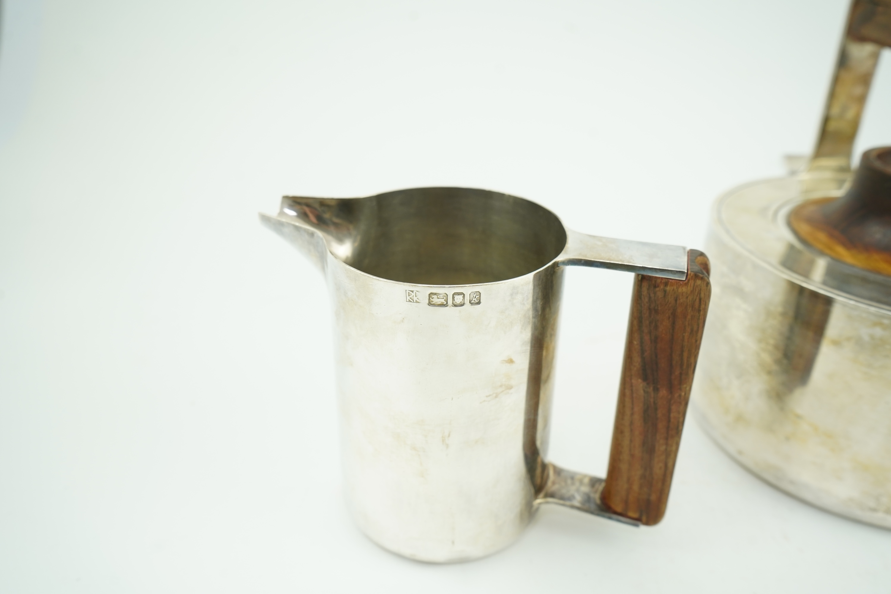 Roy Ridsdale (1942-2020): A silver tea kettle and matching cream jug